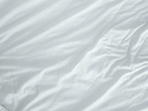 White crumpled fabric texture background. Stock Photos