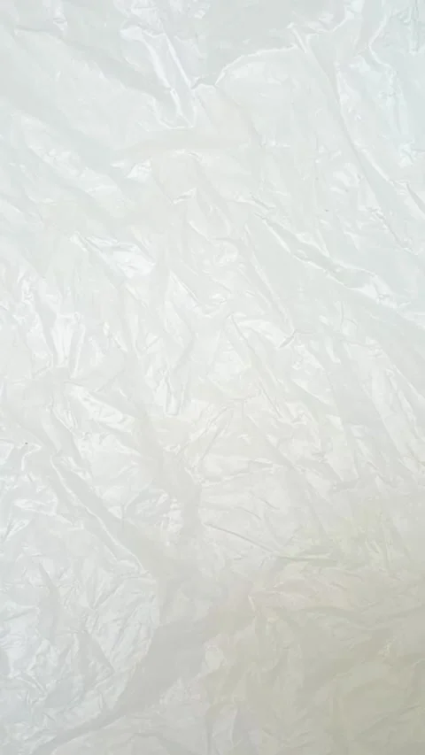White crumpled plastic bag texture background rotating. HDPE polyethylene Stock-Footage 316381375