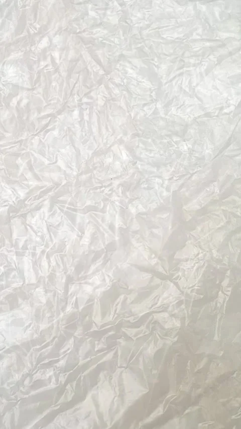 White crumpled plastic bag texture background rotating. Low-Density Polyethylene Stock Footage 316381765