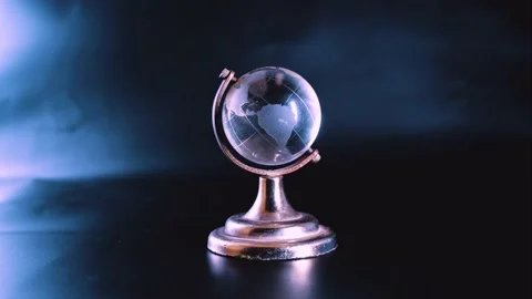 White crystal globe rotating on its own axis supporting on metal frame Stock Footage 201747651