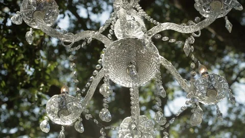 White Crystal Wedding Chandelier Under Tree, Outside 3 Stock Footage 101662016