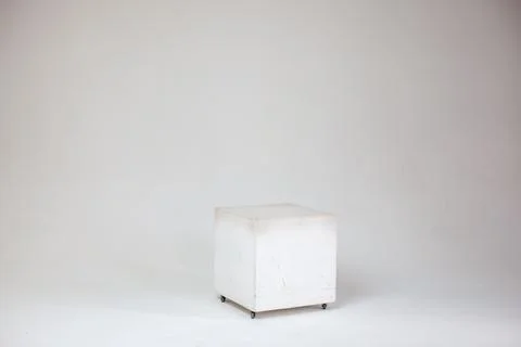 White cube on cyclorama in studio. Stock Photos