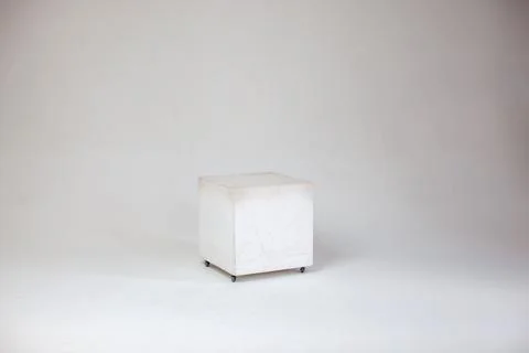 White cube on cyclorama in studio. Stock Photos