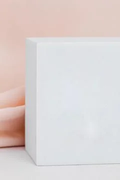 White cube platform close-up, on a background of cream cloth Stock Photos