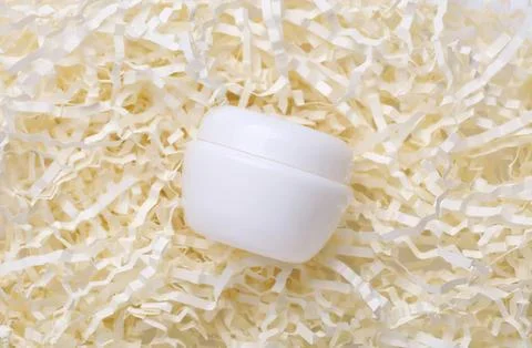 White cube on shredded paper background for mockup or display Stock Photos