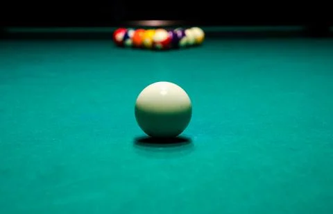 White cue ball on billiards table with racked balls Stock Photos