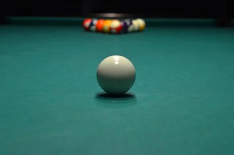 White cue ball on pool table with racked balls Stock Photos