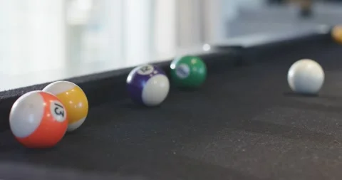 White cue ball rolling across felt pool table after strike, nudging numbered Stock Footage 341320691
