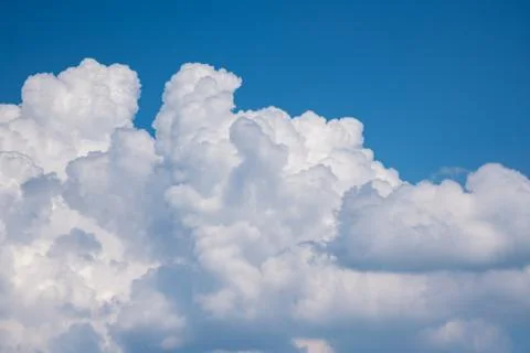 White cumulus beautiful clouds float in the blue sky. Stock Photos