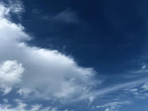 White Cumulus Cloud Against Deep Blue Sky Stock Photos