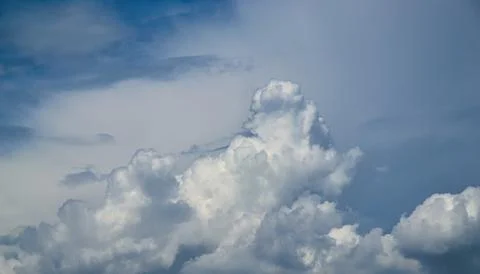White cumulus cloud formation in blue sky Stock Photos