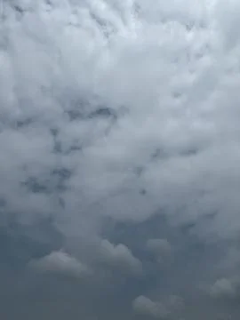 White Cumulus Clouds Across Bright Sky Stock Photos