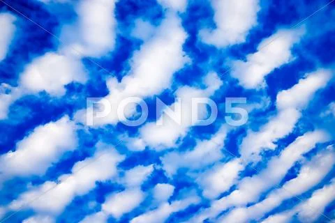 White cumulus clouds and a blue sky Stock Photos