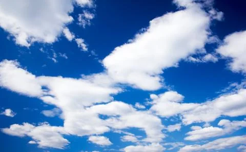 White cumulus clouds and a blue sky. Stock Photos