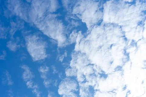 White cumulus clouds on the background of the blue sky Stock Photos