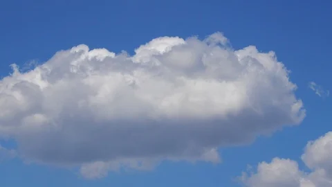 White cumulus clouds on blue background - time lapse Stock Footage 106854834