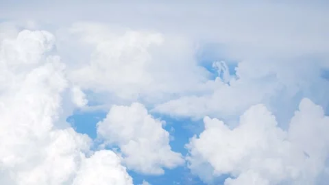 White cumulus clouds, blue sky can be seen through a dense layer of clouds Stock Footage 273171362