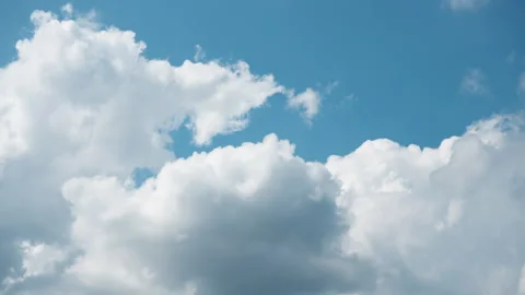 White cumulus clouds in blue sky transition into a dark storm cloud overcast Stock Footage 340039322
