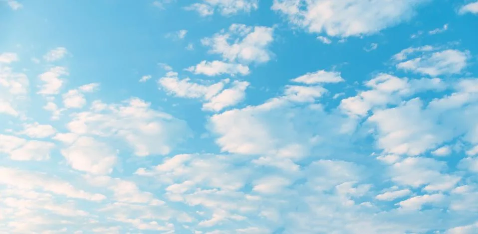 White Cumulus clouds in a blue sky Stock Photos