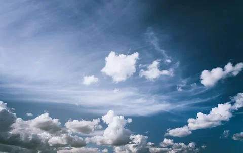 White cumulus clouds in the blue sky. Stock Photos