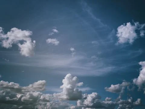 White cumulus clouds in the blue sky. Stock Photos