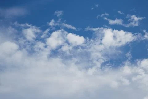 White cumulus clouds in the blue sky close-up Stock Photos
