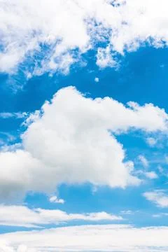 White cumulus clouds on a blue sky Stock Photos