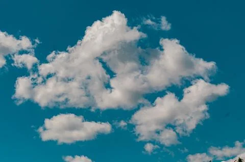White Cumulus Clouds in a Bright Blue Summer Sky Stock Photos