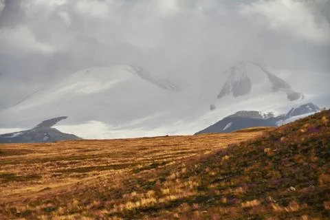White Cumulus clouds come down from the mountains, autumn landscape in the st Stock Photos