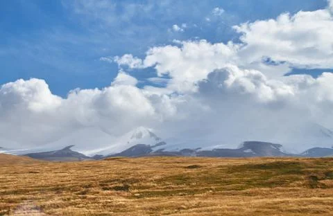 White Cumulus clouds come down from the mountains, autumn landscape in the st Stock Photos