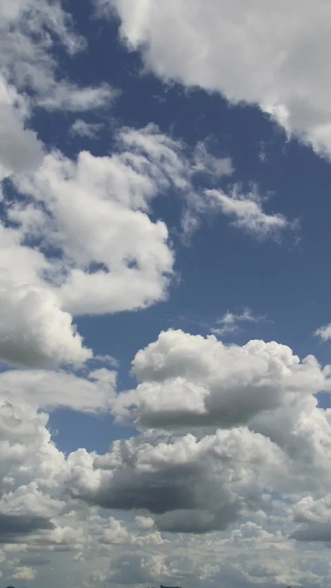 White cumulus clouds drifting across a bright blue sky in timelapse. Stock Footage 340902330