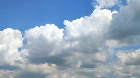 White Cumulus Clouds Drifting Slowly Across Blue Sky Stock Footage 345573166