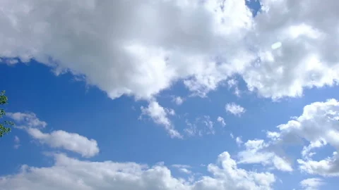 White cumulus clouds float against the blue sky, time lapse. Stock Footage 140352812