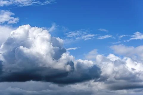 White cumulus clouds floating on a blue sky Stock Photos