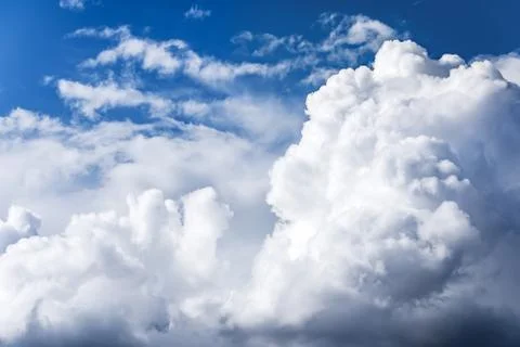 White cumulus clouds floating on a blue sky Stock Photos