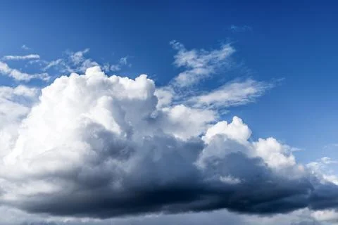 White cumulus clouds floating on a blue sky Stock Photos