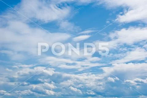 White cumulus clouds in the form of cotton wool on a blue sky. background, br Stock Photos