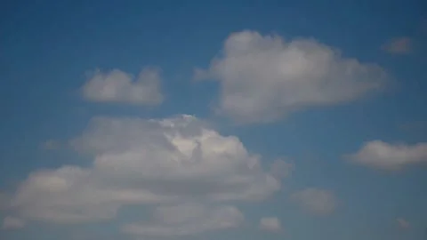 White cumulus clouds move across the blue sky. Meteorological background. Video stock 330329936