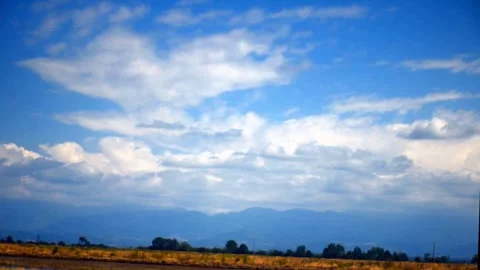 White cumulus clouds move across the blue sky. Meteorological background. Stock Footage 330393243