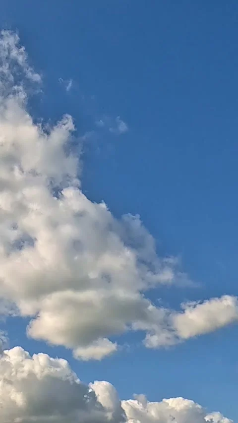 White cumulus clouds moving across deep blue summer sky. timelapse Stock Footage 318221384