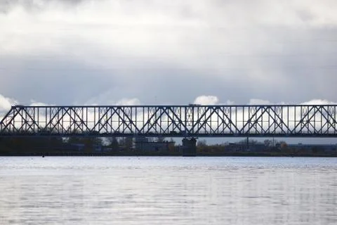 White cumulus clouds pass bridge over the Northern Dvina River. Stock Photos