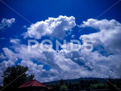 White Cumulus Clouds On Sunny Day At Labuhan Aji, North Bali Stock Photos