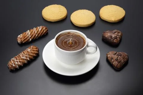 White cup of black coffee with biscuits on a dark background Stock Photos