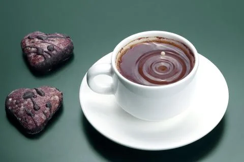 White cup of black coffee with biscuits on a dark background Stock Photos