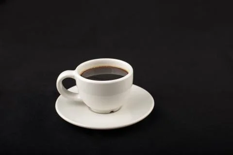 White cup of black coffee in the dark Stock Photos