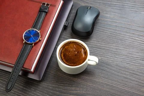 White cup of black coffee on the office table next to the laptop and busine.. Stock Photos