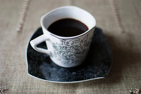 White cup of black coffee on a table  Stock-Fotos