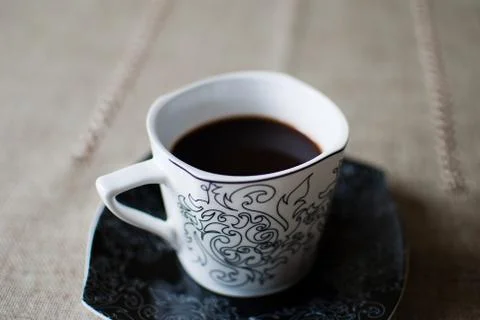 White cup of black coffee on a table  Stock Photos