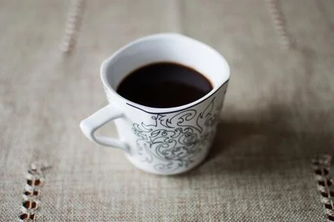 White cup of black coffee on a table  Stock Photos