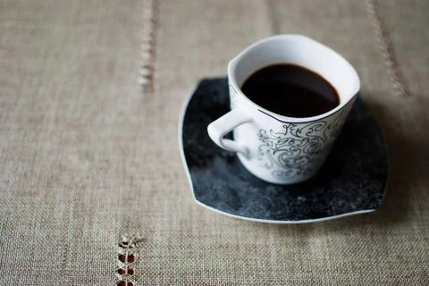 White cup of black coffee on a table  Stock-Fotos